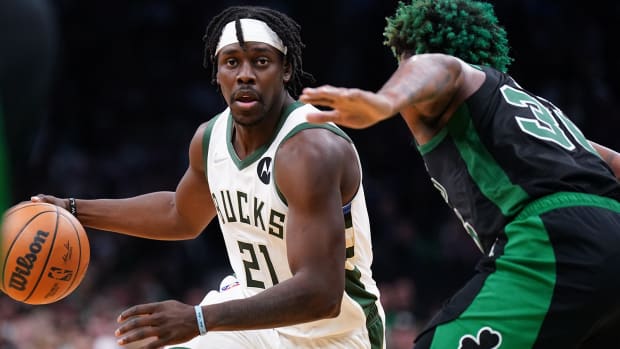 Milwaukee Bucks guard Jrue Holiday (21) drives the ball against Boston Celtics guard Marcus Smart.
